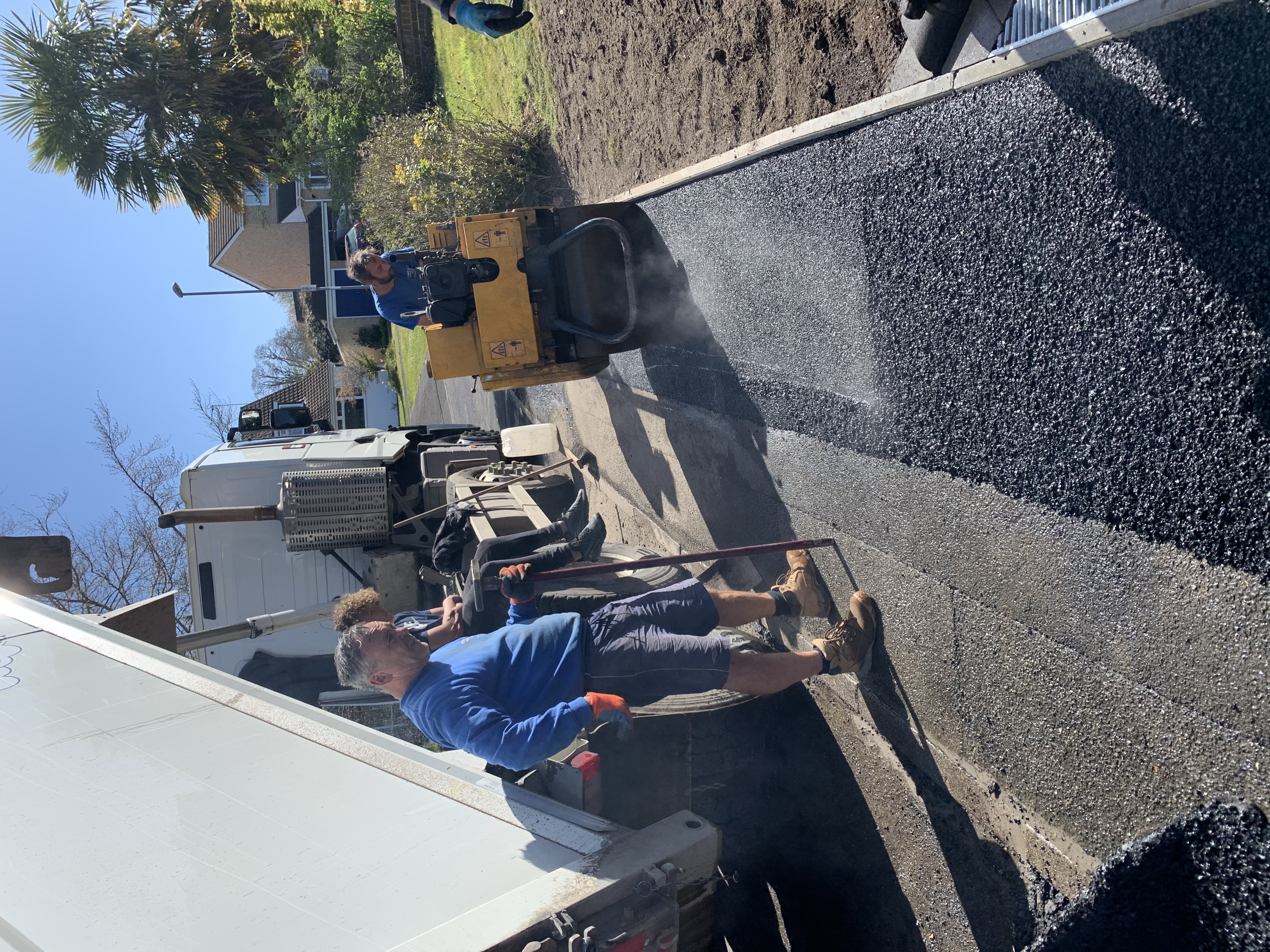 White & Sons laying a tarmac dropped kerb crossing