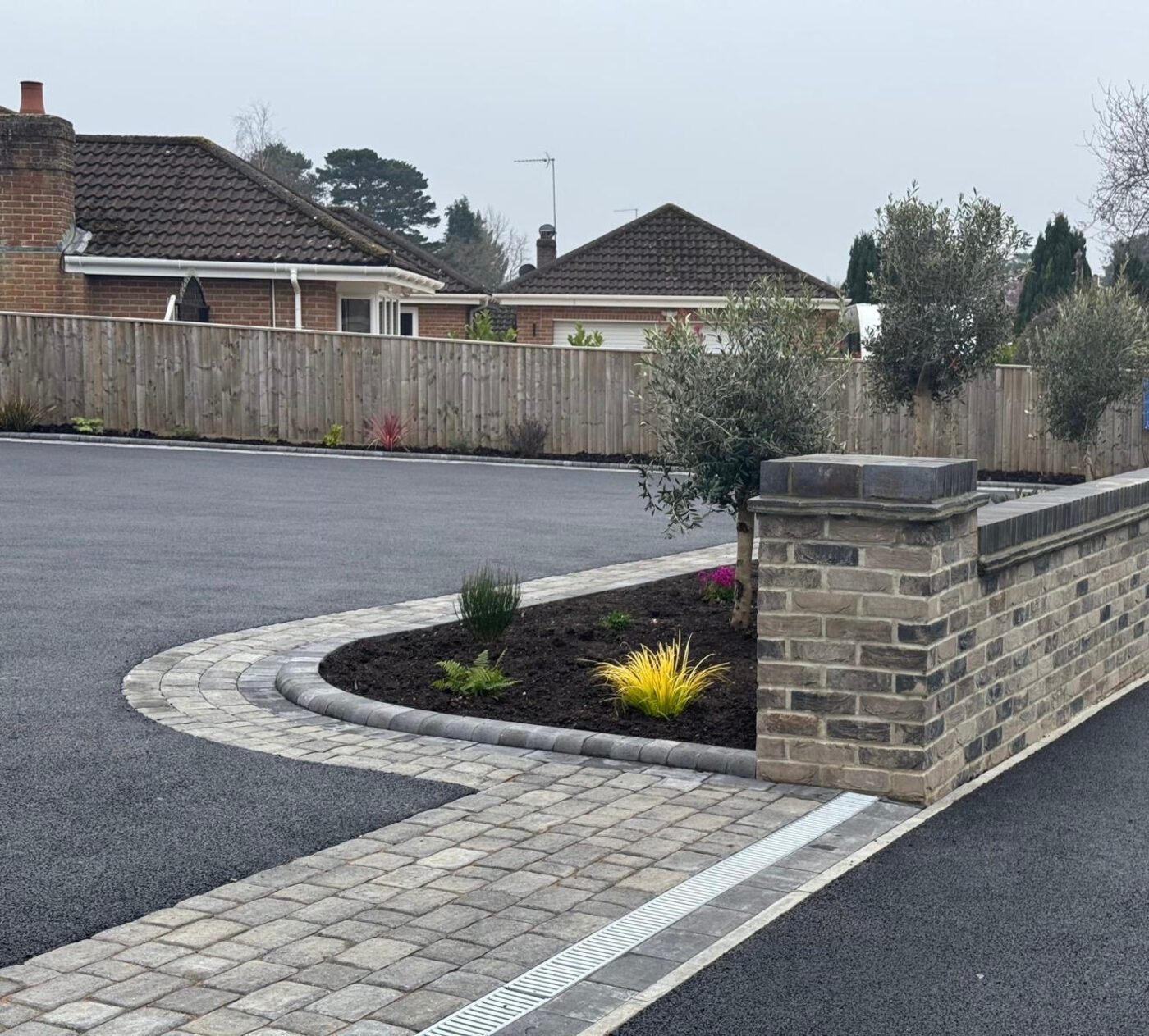 Modern block paving driveway with planted border, Dorset