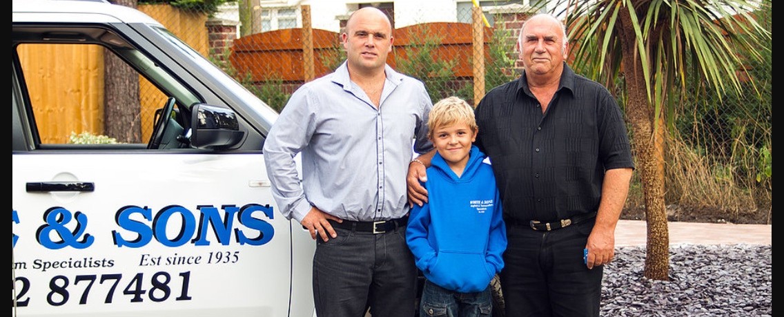 Three generations of the White family by the company van, 2009